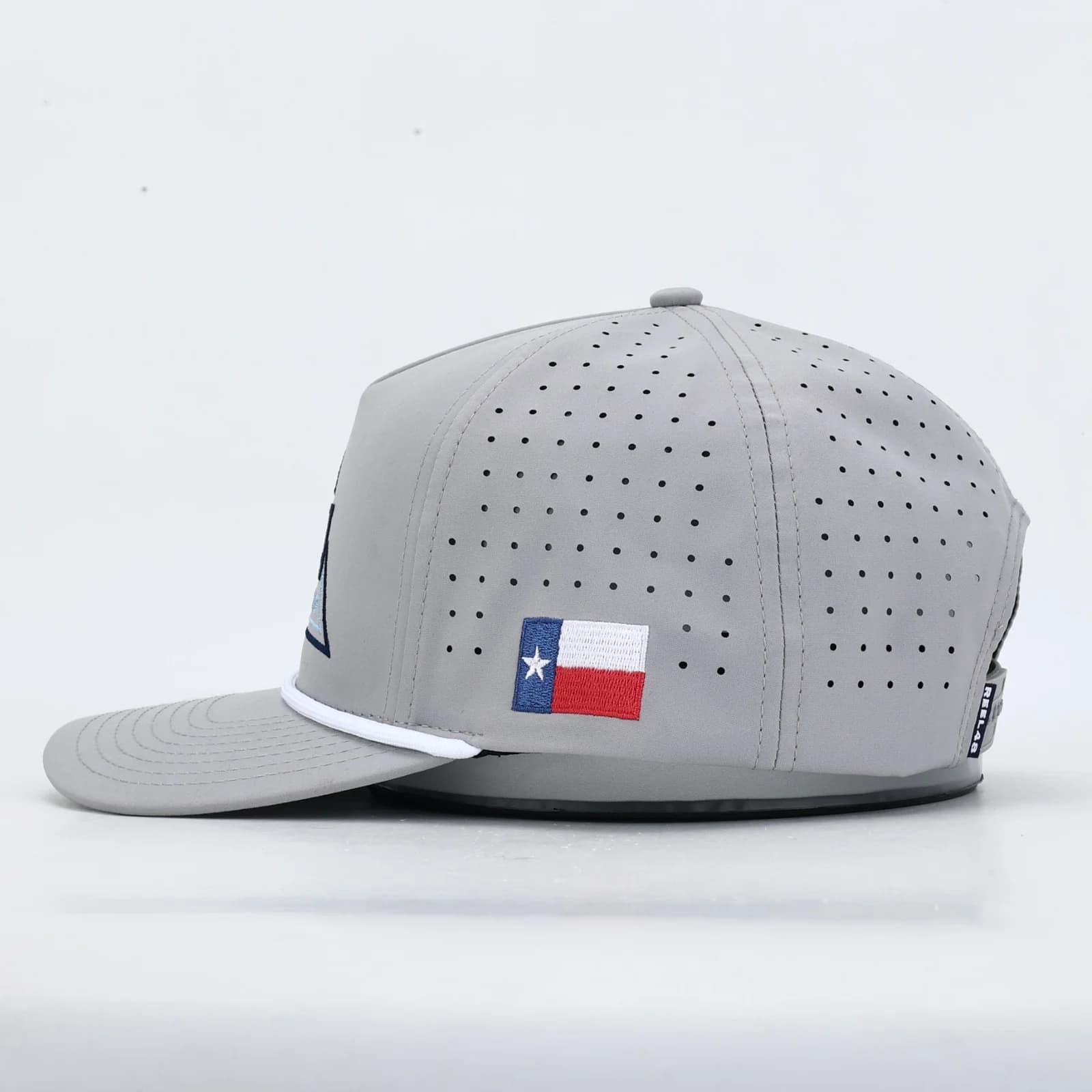 Side of a grey Delta cap with an embroidered Texas flag