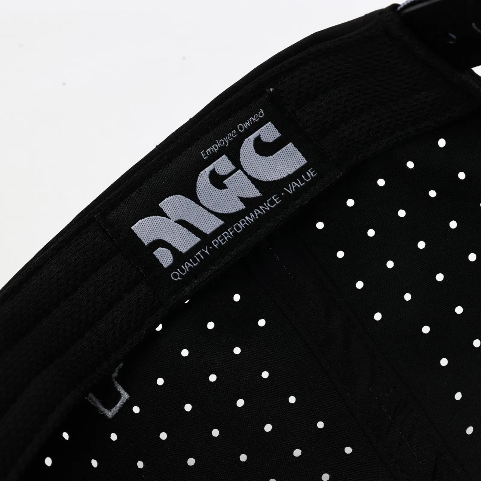 Woven MGC label inside a black perforated cap