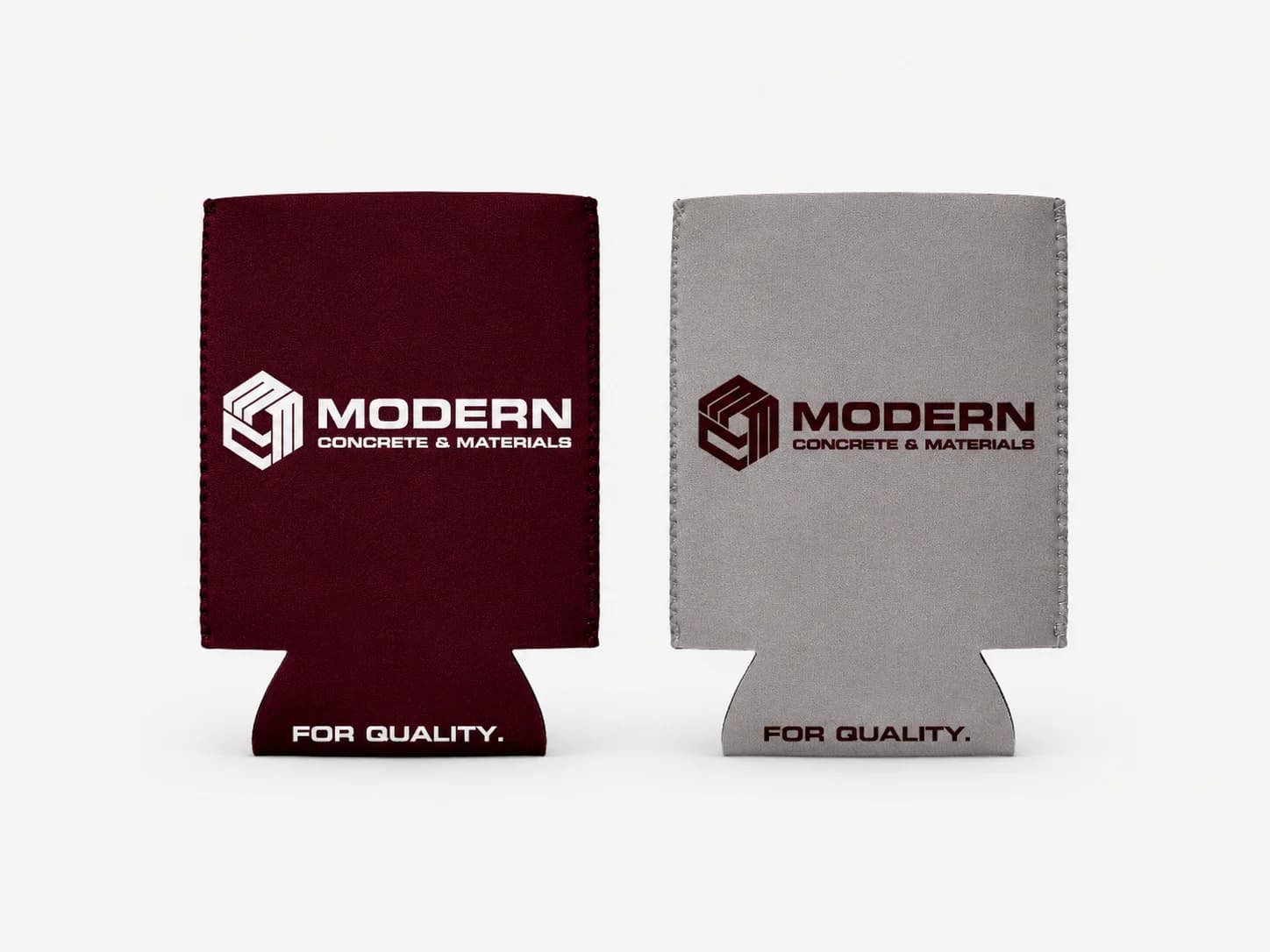 Maroon and grey can coolers printed with the Modern Concrete & Materials logo